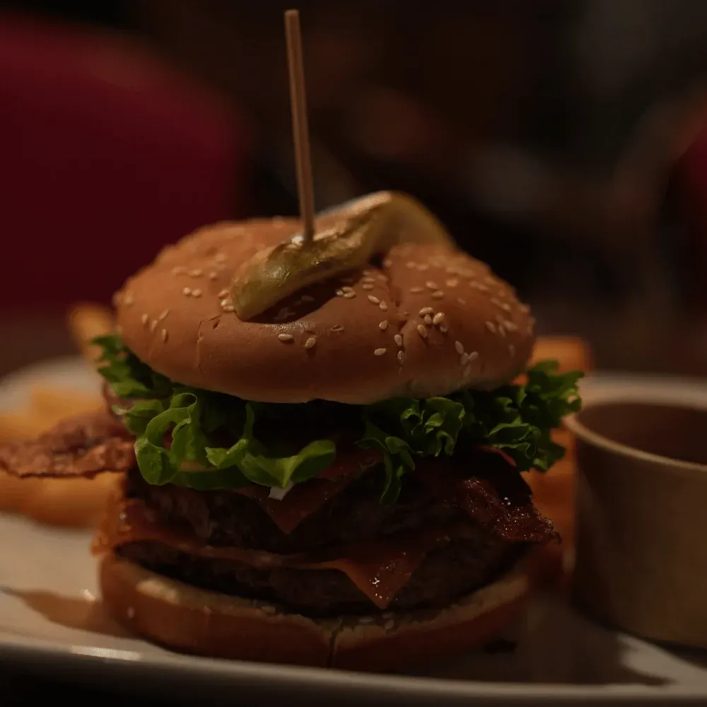 Double bacon cheeseburger with a pickle on top