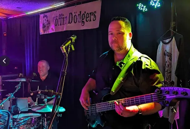 A bassist performing live at Kicks Saloon