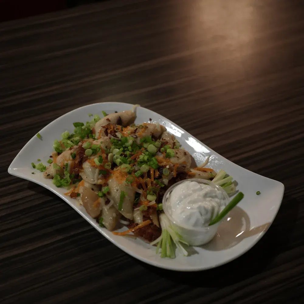 Loaded perogies with bacon, cheese and sour cream