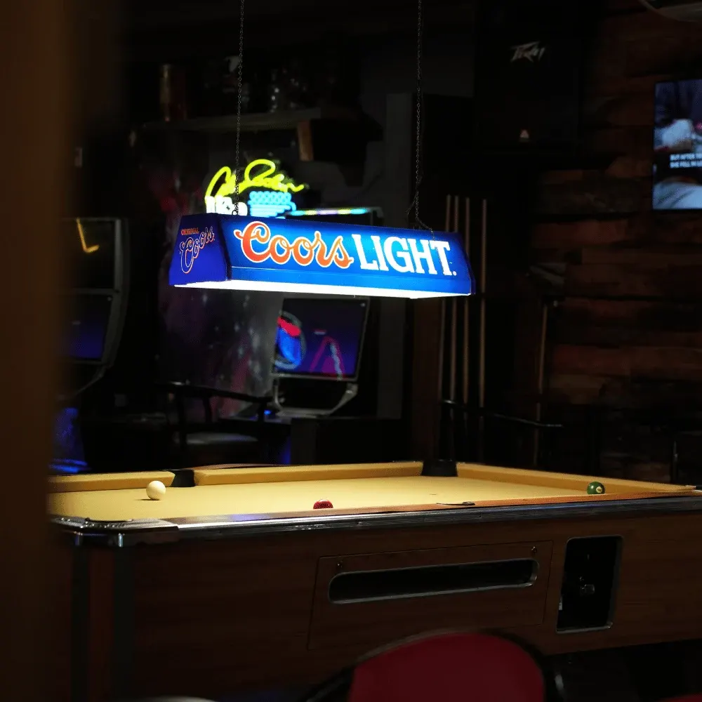 The pool table under the Coors Light lamp at Kicks Saloon