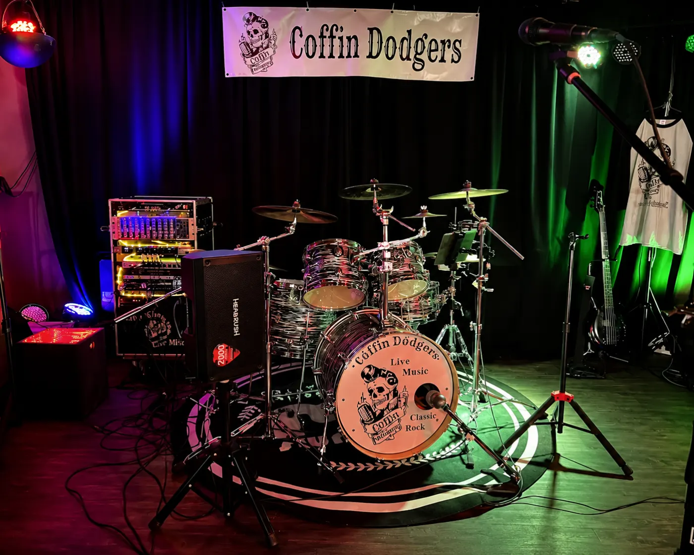 The Coffin Dodgers' stage set up with drums and coloured lights at Kicks Saloon